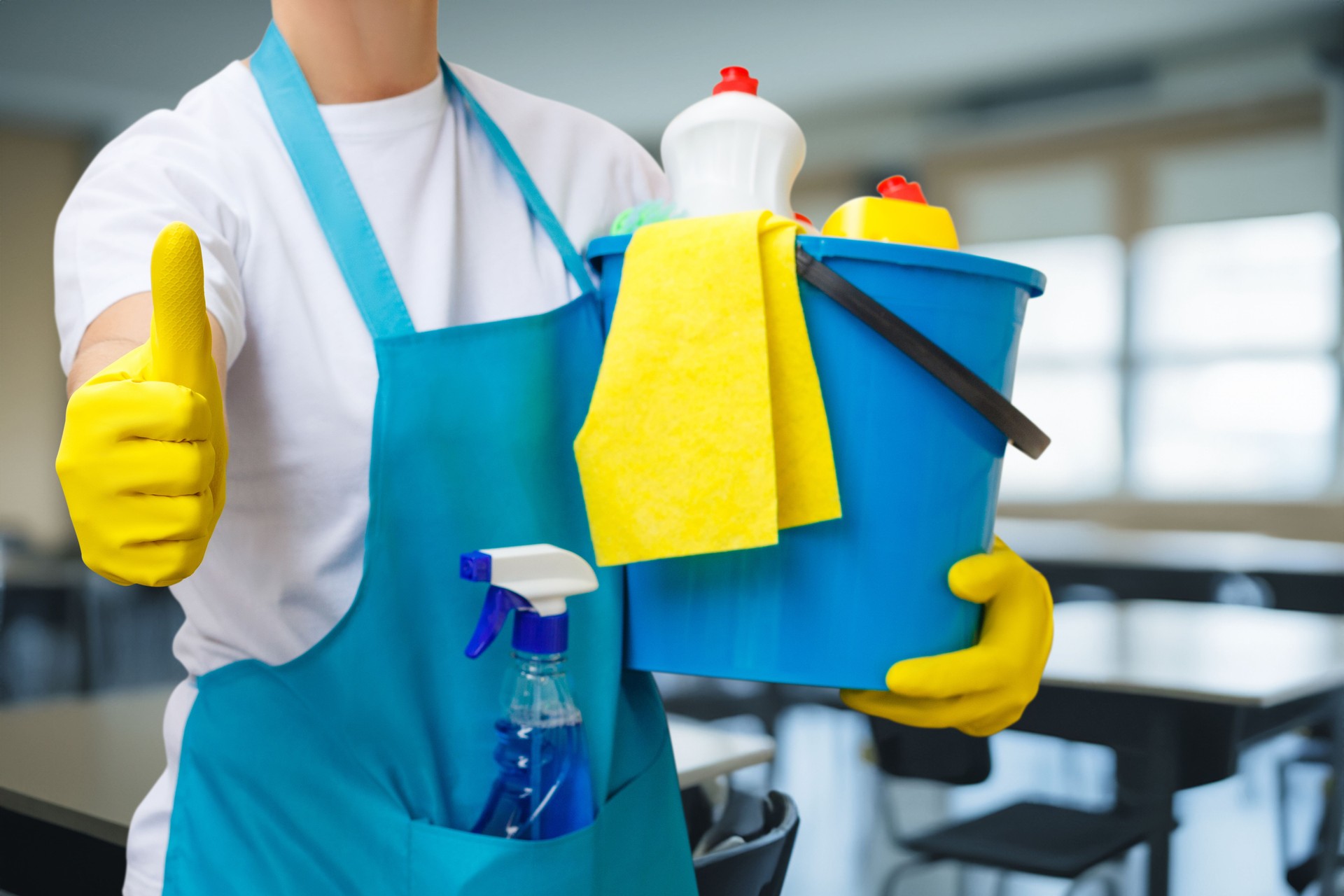 Joyful cleaner showcases teamwork in bright classroom setting.